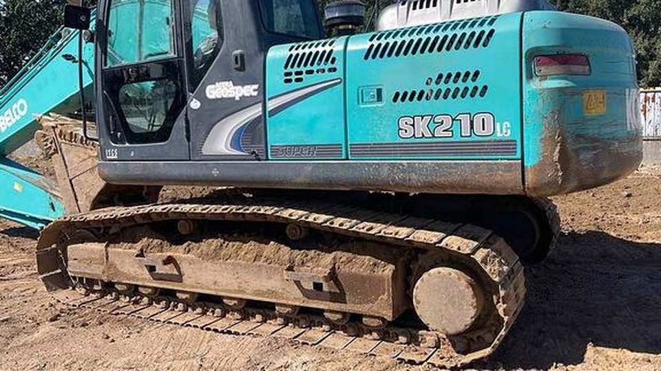 Side view of a Kobelco SK210LC excavator