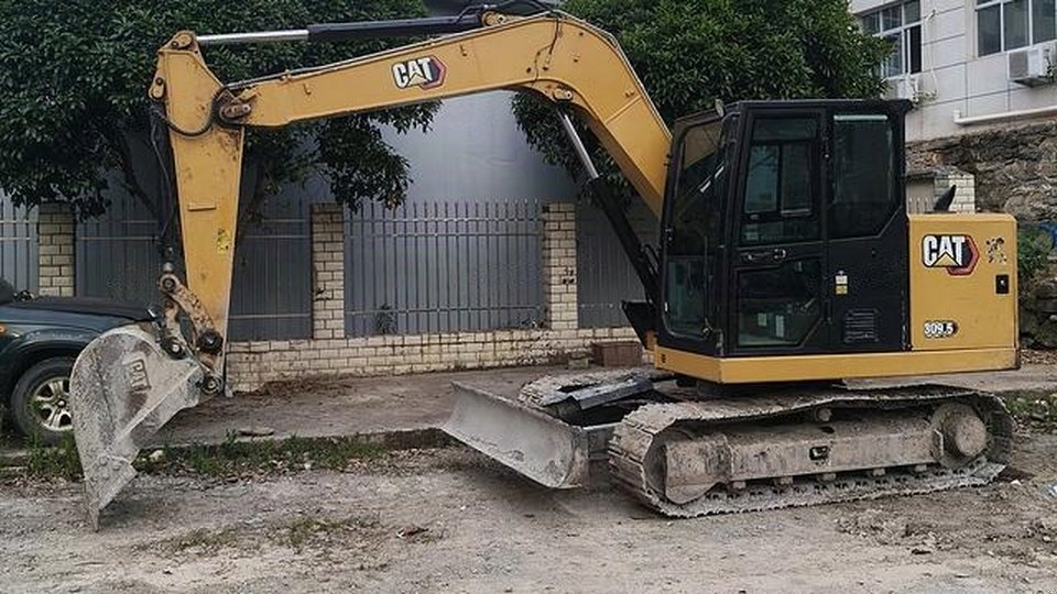Used Caterpillar 309.5 excavator with a dozer blade
